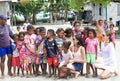 Group of children interacting with two european girls in Raja Am