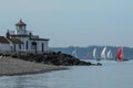 West Point Lighthouse with Sailboat Race in Background Royalty Free Stock Photo