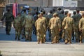 Group of soldier cadets walking down a street in formation wearing their fatigue uniforms