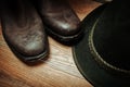 West rodeo cowboy dirty and used brown botts and hat Royalty Free Stock Photo