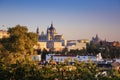 The west wing of Royal Palace of Madrid and Cathedral of Santa MarÃÂ­a la Real de la Almudena illuminated with sunset view from the