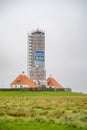 Westerhever Lighthouse construction site during autumn, north sea, germany, vertical shot during cloudy day Royalty Free Stock Photo