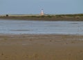 Westerhever lighthouse from a distance over green meadows and the north sea Royalty Free Stock Photo