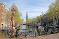 Westerkerk Church clock tower and historic buildings viewed from Reestraat Bridge along Prinsengracht Canal in Amsterdam