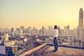 Western businessman looking at the city at sunset