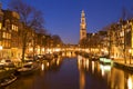 The Western Church and a canal in Amsterdam at night Royalty Free Stock Photo