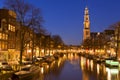 The Western Church and a canal in Amsterdam at night Royalty Free Stock Photo