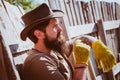 Western cowboy portrait. Bearded man gardener in an urban garden. Rural scene. Gardening hobby. Royalty Free Stock Photo