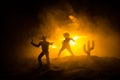 Western cowboy silhouette with texture at sunset and slivers of light