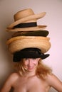 Western girl wearing many hats Royalty Free Stock Photo