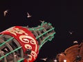 Western Gulls fly around giants Coca-Cola bottle