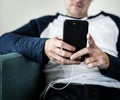 Western guy listening music on his mobile phone Royalty Free Stock Photo