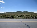 Western highway, mountain and blue sky Royalty Free Stock Photo