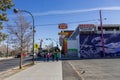 The Western Hotel with a colorful wall mural and cars on the street, people walking on the sidewalk with blue sky Royalty Free Stock Photo