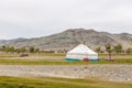 Western Mongolia mountainous landscape. View of nomadic camp. Yurt camp