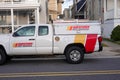 A Western Pest Services truck parked at the side of a street in front of several houses
