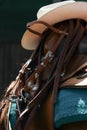 Western saddle with cowboy hat and leather harness Royalty Free Stock Photo