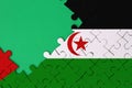 Western Sahara flag is depicted on a completed jigsaw puzzle with free green copy space on the left side