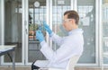 A western scientist man using hologram tablet with copy space to analysis and develop vaccine of covid-19 virus in lab or