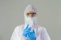 A western scientist woman with Covid-19 suit and mask holding test tube to analysis vaccine of covid-19 virus in lab or laboratory