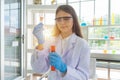 A western scientist woman working on test tube to analysis and develop vaccine of covid-19 virus in lab or laboratory in