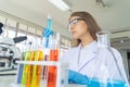 A western scientist woman working on test tube to analysis and develop vaccine of covid-19 virus in lab or laboratory in