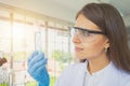 A western scientist woman working on test tube to analysis and develop vaccine of covid-19 virus in lab or laboratory in