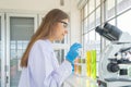 A western scientist woman working on test tube to analysis and develop vaccine of covid-19 virus in lab or laboratory in