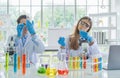 A western scientists couple working on test tube to analysis and develop vaccine of covid-19 virus in lab or laboratory in Royalty Free Stock Photo