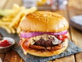 Western style bacon burger with onion rings and bbq sauce Royalty Free Stock Photo