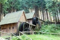 Western style pioneer frontier water mill wheel wooden building in the forest Royalty Free Stock Photo