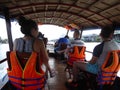 Western tourists on tour boat in the Mekong river delta Vietnam