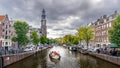 Westertoren tower seen from the intersection of the Leliegracht and Prinsengracht canals in the Jordaan neighborhood in Amsterdam