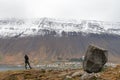 Westfjords of Iceland Naustahvilft The Troll Seat person looking towards Isafjoerdur