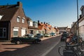 Westkapelle, The Netherlands, August 2019. A street in the town: the characteristic brick houses overlook the street. A couple is
