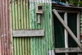 Westland New Zealand - May 1 2022; Old rustic red and green whitebaiters shack with humorous handwritten sign