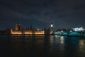 The Westminster Bridge and the Big Ben clocktower by the Thames river in London in the night Royalty Free Stock Photo