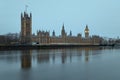 The Westminster Palace and the Big Ben clocktower by the Thames river in London at dawn Royalty Free Stock Photo