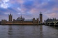 Westminster Palace and Big Ben covered in scaffolding for restoration viewed across the Thames at sunset in London, UK Royalty Free Stock Photo