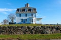 Howland House, formerly a hotel, sits behind an old stone wall in Westport MA, on a clear winter day