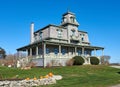 A Victorian House with a large wrap-around porch and mansard roof in Westport Ma