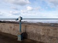 WESTWARD HO, DEVON, ENGLAND - JANUARY 25, 2021: Old Viewpoint coin operated telescope overlooks beach.