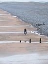 Bike rider on a deserted beach UK Royalty Free Stock Photo