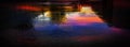 Wet asphalt after rain, reflection of neon lights in puddles. The lights of the night, neon city. Abstract dark background. Royalty Free Stock Photo