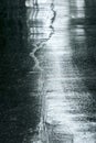 Wet sidewalk in rainy day. water puddles on street road surface. Royalty Free Stock Photo