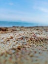 wet beach sand texture with bokeh background of sea waves and cloudy blue sky Royalty Free Stock Photo