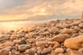 Wet beach stones sea shore horizon with mountains and fairy clouds above Royalty Free Stock Photo