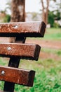 Wet bench in the park in the rain. Rainy weather. Wooden chair in the rain. Wet urban furniture. Rain drops on wooden Royalty Free Stock Photo