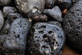 Wet black volcanic stones on the shore - Image Royalty Free Stock Photo