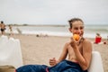 Wet boy eating peach on the beach and laughing Royalty Free Stock Photo